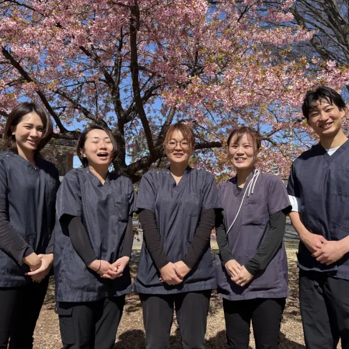 河津桜の下で並ぶトータルケアふじみ野のスタッフ